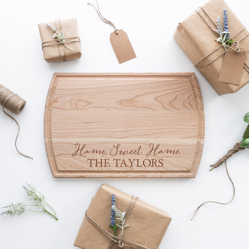 Engraved cutting board with giftwrap surrounding it